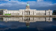 Time Lapse Of Custom House Historical Building In Dublin City During Daytime With Reflection On Liffey River In Ireland.