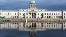 Time Lapse Of Custom House Historical Building In Dublin City During Daytime With Reflection On Liffey River In Ireland.
