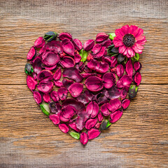 Valentine day, Love symbol, Heart shape design from pink flowers and dried bark from nature on wooden background.