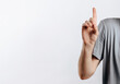 © Daria Lukoiko - Portrait of cheerful young handsome man smiling looking at camera pointing finger upwards on white background with space for advertising mock up