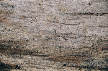 Dark brown aged wooden textured rough background with stains and cracks.