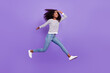 © deagreez - Full length body size view of pretty cheerful girl jumping running meet friend isolated over violet purple color background