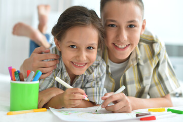 Wall Mural - Porait of smiling brother and sister drawing together