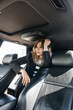 © Gitarina - Young beautiful girl sitting in a car.