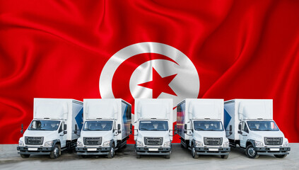 Tunisia flag in the background. Five new white trucks are parked in the parking lot. Truck, transport, freight transport. Freight and logistics concept