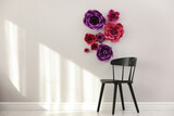 Fototapeta  - Stylish room interior with floral decor and black chair, space for text