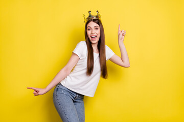 Poster - Portrait of attractive trendy cheerful girl wearing crown dancing having fun isolated over bright yellow color background