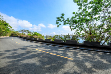 Empty asphalt road and mountain scenery on sunny day.