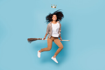 Wall Mural - Full length body size view of attractive cheerful girl jumping riding mop wearing crown isolated over bight blue color background