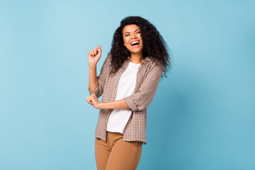 Poster - Photo of funny charming dark skin woman dressed checkered shirt dancing smiling isolated blue color background