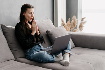 Young woman looking at laptop display with shocked face