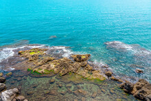  Many Big And Small Rocks And Sea Waves Hitting The Rocks. Blue Sea Waves Background And Sky Beautiful Landscape.