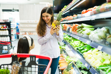 Wall Mural - Young family laughing at the grocery store