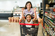 Woman laughing with her kid at the grocery store