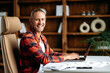 © Kateryna - Portrait of joyful successful confident young adult caucasian freelancer or manager, using laptop. Handsome guy working distantly, sits at work desk, looking at the camera, smiling