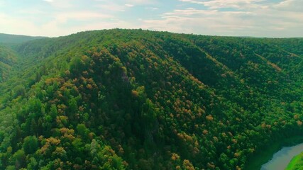 Wall Mural - Aerial video of clouds, mountains, forest and mountain river