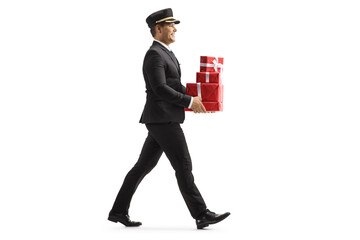 Poster - Full length profile shot of a porter carrying a pile of presents