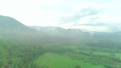 Wall Mural - Aerial video of clouds, mountains, forest and mountain river