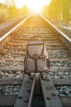 Backpack On The Train Tracks. Tourism, Travel, Trip Concept