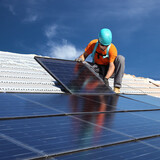 Fototapeta  - Man installing solar panels