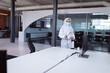 © wavebreak3 - Cleaner wearing ppe suit, glasses and mask disinfecting office workspace