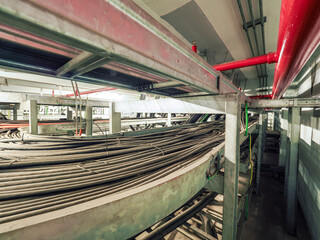 Power cables and instrument cables were installed with cable trays in electric cable room of power plant which show metal material of tray and black high voltage cable.