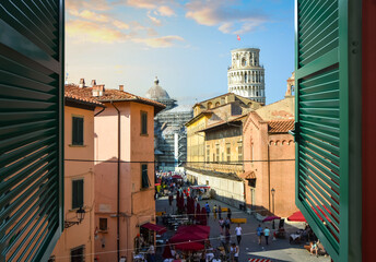 Wall Mural - View through an open window with shutters of the Leaning Tower of Pisa and Duomo dome from a room along Via Santa Maria, in Pisa Italy