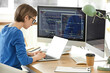 © Pixel-Shot - Female programmer working with laptop in office