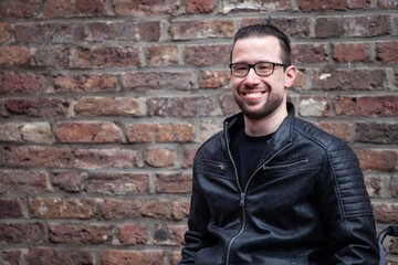 Poster - man in wheelchair in front of brick wall