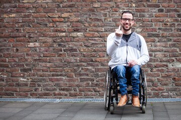 Wall Mural - man in wheelchair giving the middle finger