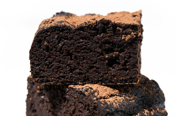 dessert - pieces of chocolate brownies on white background, closeup