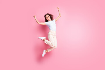 Wall Mural - Full size profile photo of hooray nice brunette hair lady jump wear t-shirt pants isolated on pink background