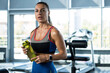© nazarovsergey - Sporty girl drinking water after workout at gym