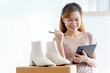 © Nonwarit - Asian young start up small business owner packing shoes in the box at workplace. Online selling, woman seller prepare product for packaging process at home, internet marketing, e-commerce concept