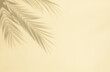 Palm leaf shadow on pastel beige background