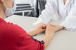 © Nonwarit - Hand of doctor reassuring her female patient. Asian people