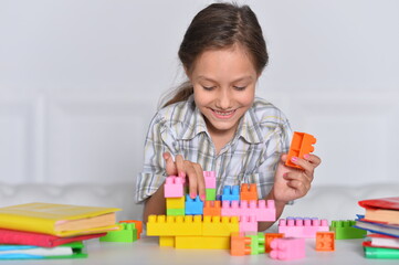 Canvas Print - Porait of happy cute little girl playing with cubes