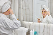 © Rychko Yevhen - beautiful woman with eye patches in white bathrobes in bathroom