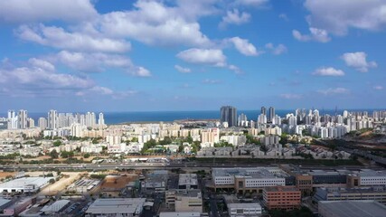 Wall Mural - Aerial view of the city of Netanya over the industrial area, overlooking the city skyline.
