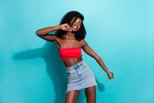 Photo of happy positive young dark skin woman dance summer outfit isolated on teal color background