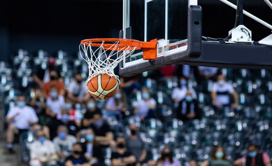 Wall Mural - basketball going through the hoop at a sports arena