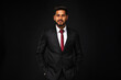 © Тарас Нагирняк - Portrait of young indian business man in black suit on black isolated background
