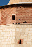 Fototapeta  - Birds Doves Rest On Tower Of Zaraysk Kremlin In Winter In Zaraysk, Moscow Region, Russia.
