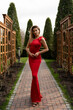 © Svetlana Sokolova - Gorgeous woman in elegance red long  silk dress posing in summer  park.  Perfect wavy hairs. Full lenght.