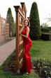© Svetlana Sokolova - Gorgeous woman in elegance red long  silk dress posing in summer  park.  Perfect wavy hairs. Full lenght.
