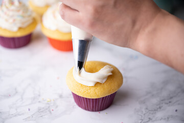 Canvas Print - pipping flosting on colorful cupcake