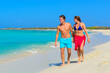 © TRAVEL EASY - Young beautiful couple walking and relaxing on the beach