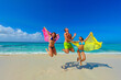 Three young beautiful people jumping for joy on the beach, interracial, black  