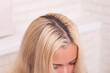 
Strands of long blonde hair before color correction in hairdressing salon
