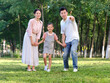 © eastfenceimage - Happy family of three playing in the park
